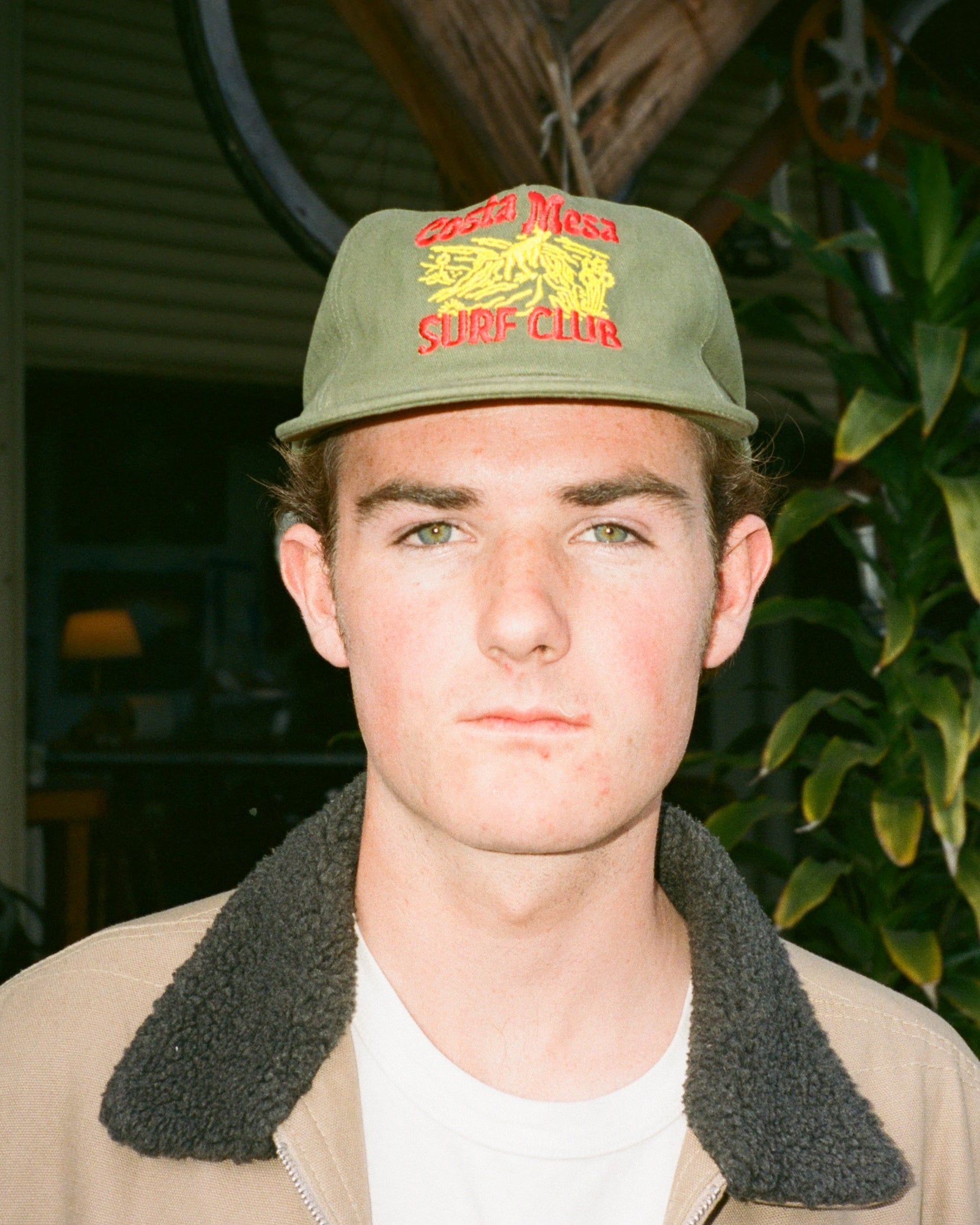 Person wearing a cap with a logo outdoors